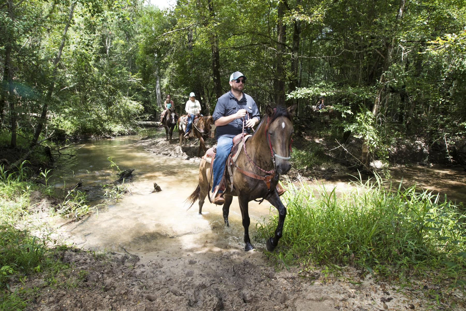 People riding horses at Bogue Chitto